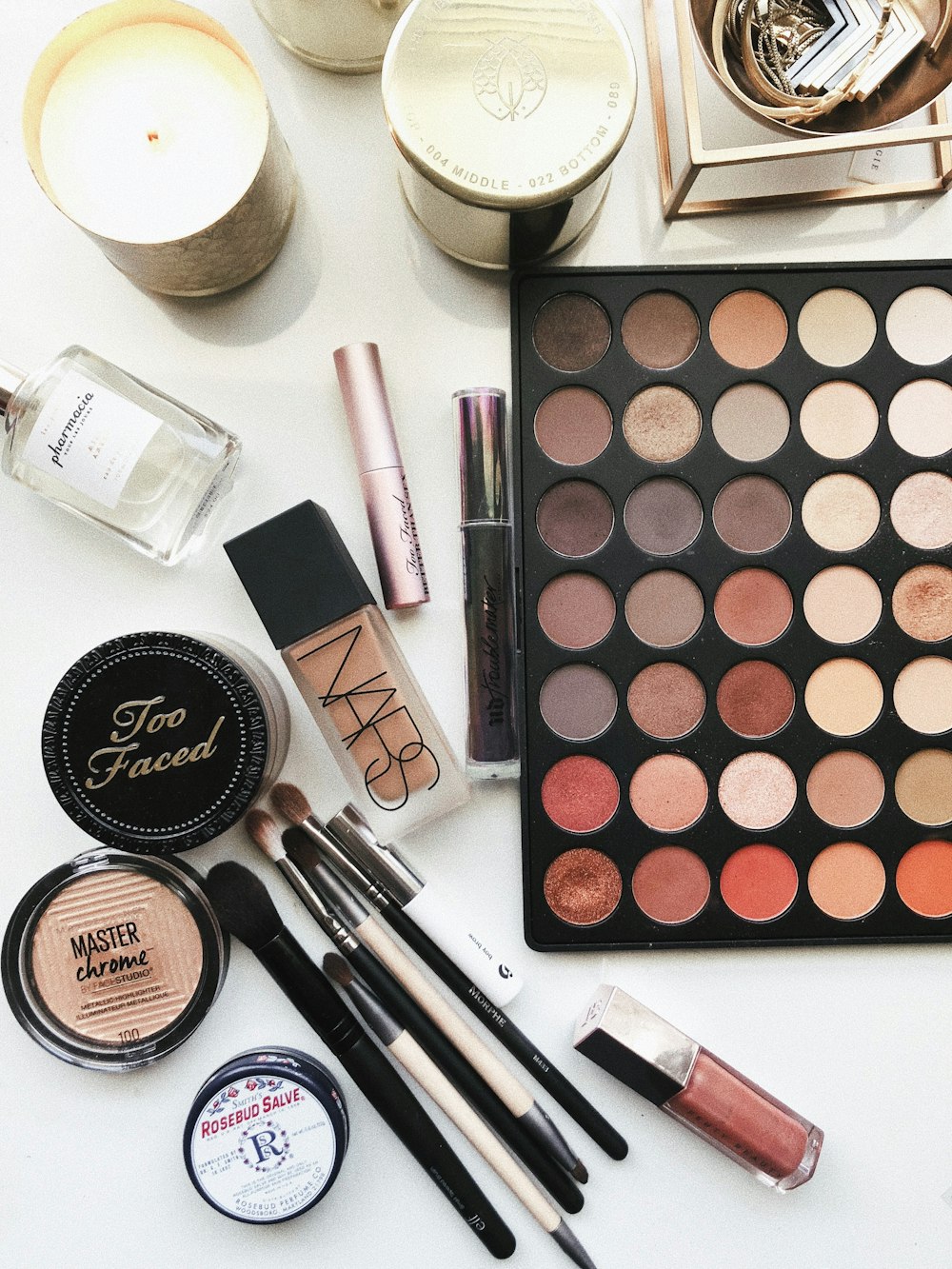Flatlay of professional makeup products and an eyeshadow palette